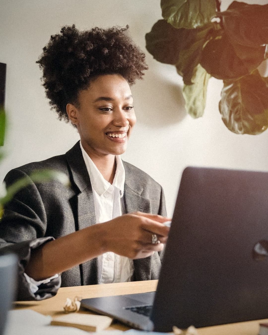 A business owner laughing at her laptop