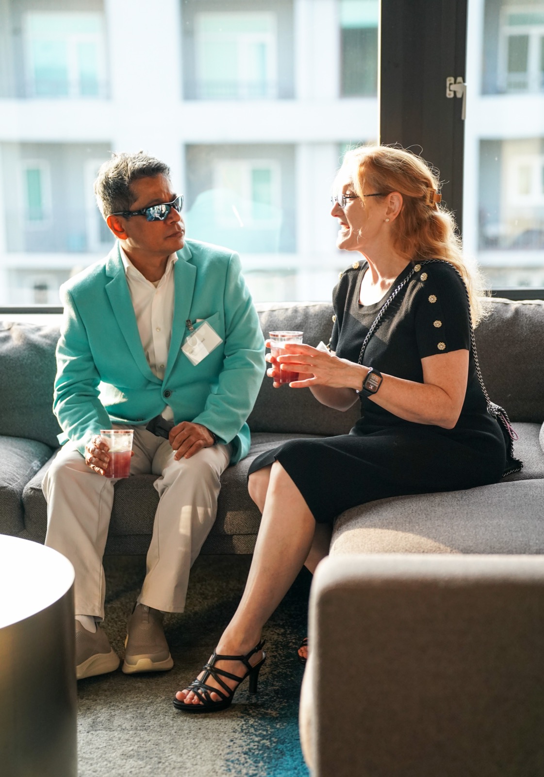 Two guests talking on a sofa at the Vantage launch party